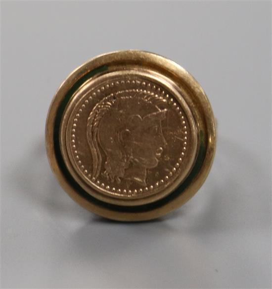 A yellow metal mounted coin ring, size J.